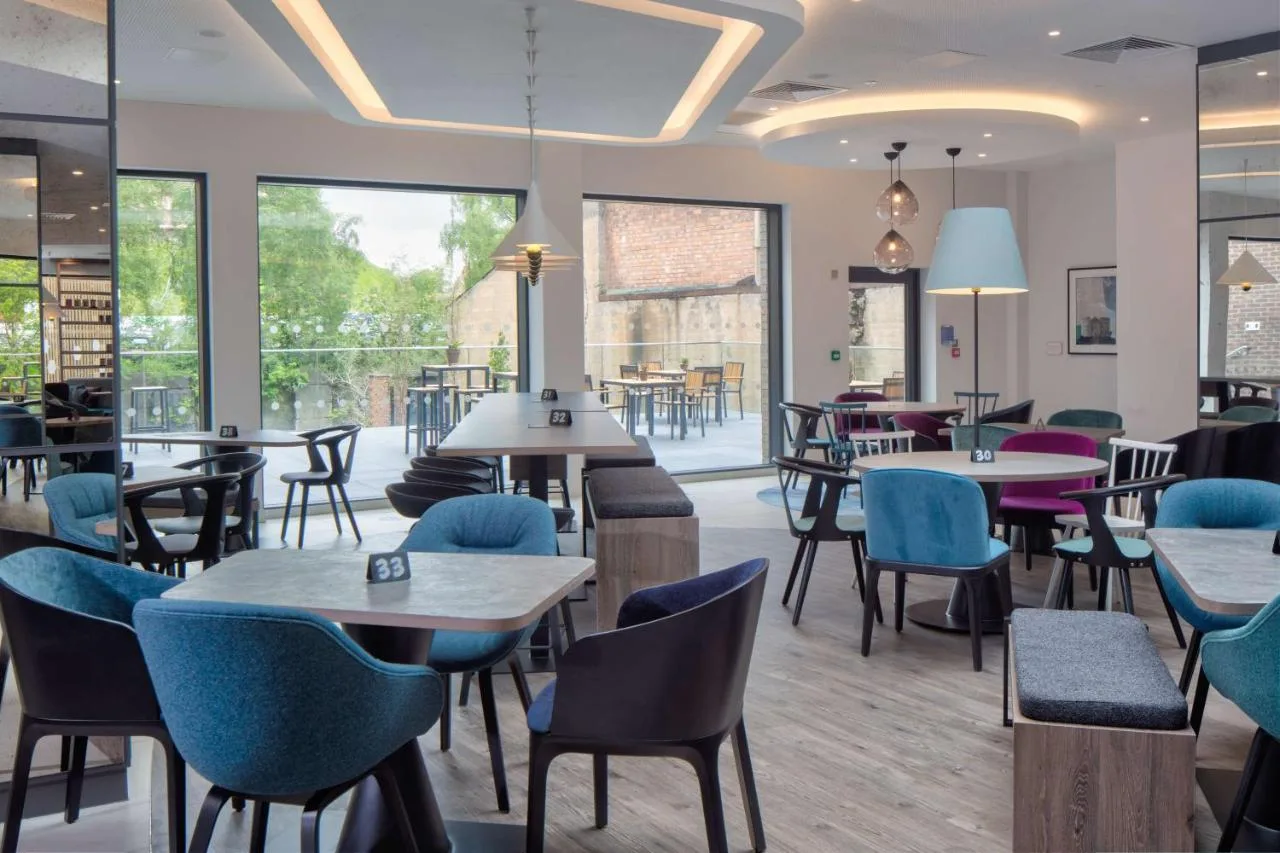 Bright breakfast restaurant with tables and chairs at Hampton by Hilton York Piccadilly