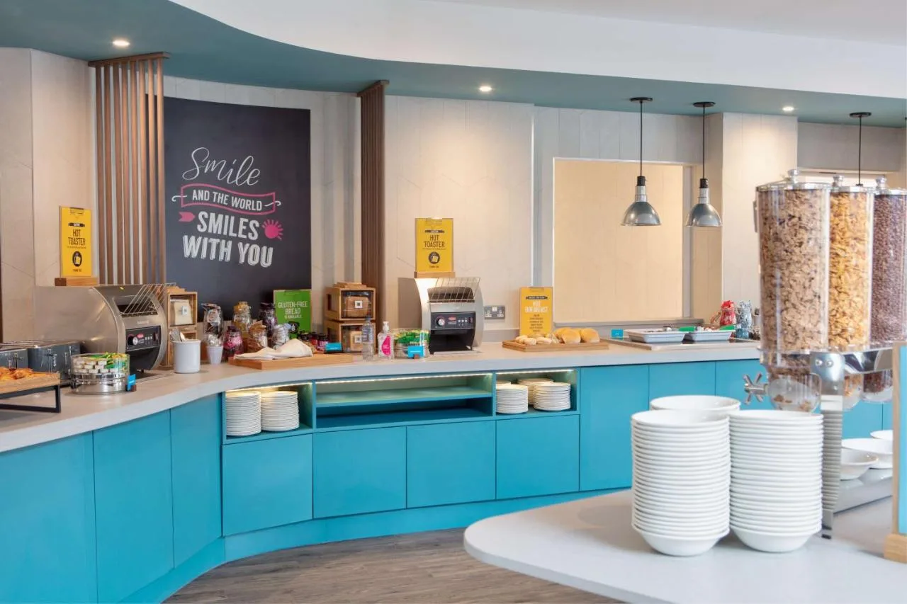 Hotel kitchen with blue cabinets and white plates at Hampton by Hilton York Piccadilly